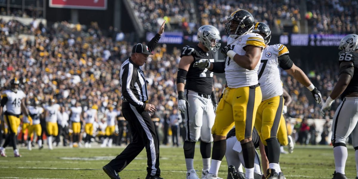 NFL referee spots the ball during Steelers/Raiders game