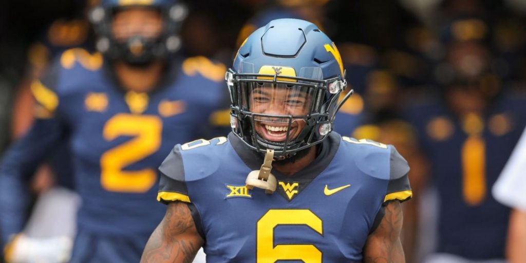 West Virginia Mountaineers safety Devon Askew-Henry runs onto the field before a game in 2018