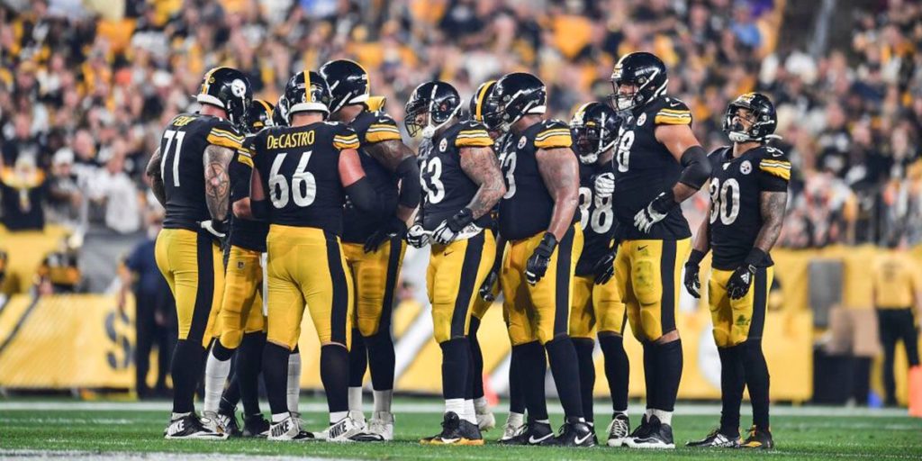 The Pittsburgh Steelers offense huddles before a play against the Cincinnati Bengals in Week 4 of the 2019 NFL regular season