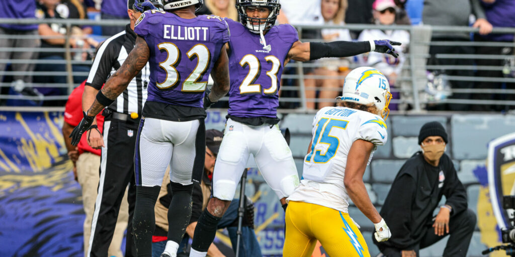 Baltimore Ravens cornerback Anthony Averett (23) celebrates a defensive stop with free safety DeShon Elliott (32) against Los Angeles Chargers wide receiver Jalen Guyton (15)