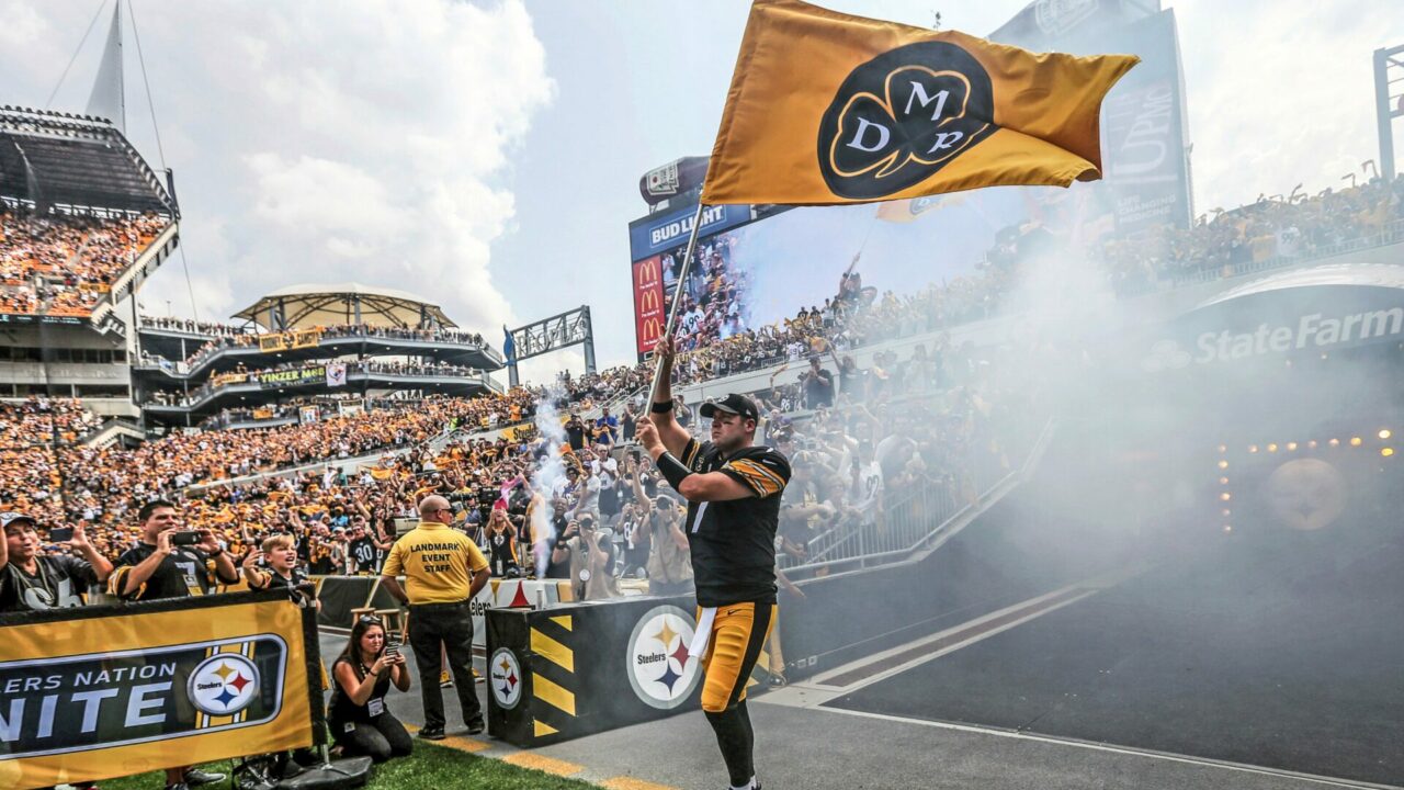 Pittsburgh Steelers quarterback Ben Roethlisberger (7) waves a DMR flag in honor of the late Dan Rooney